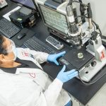 Isola Woman Working With Microscope Inline